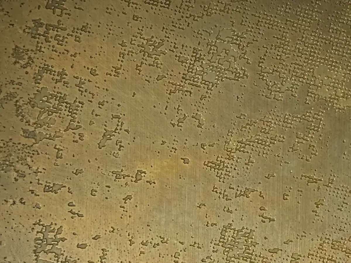 Etched bronze decorative metal panel sample close-up