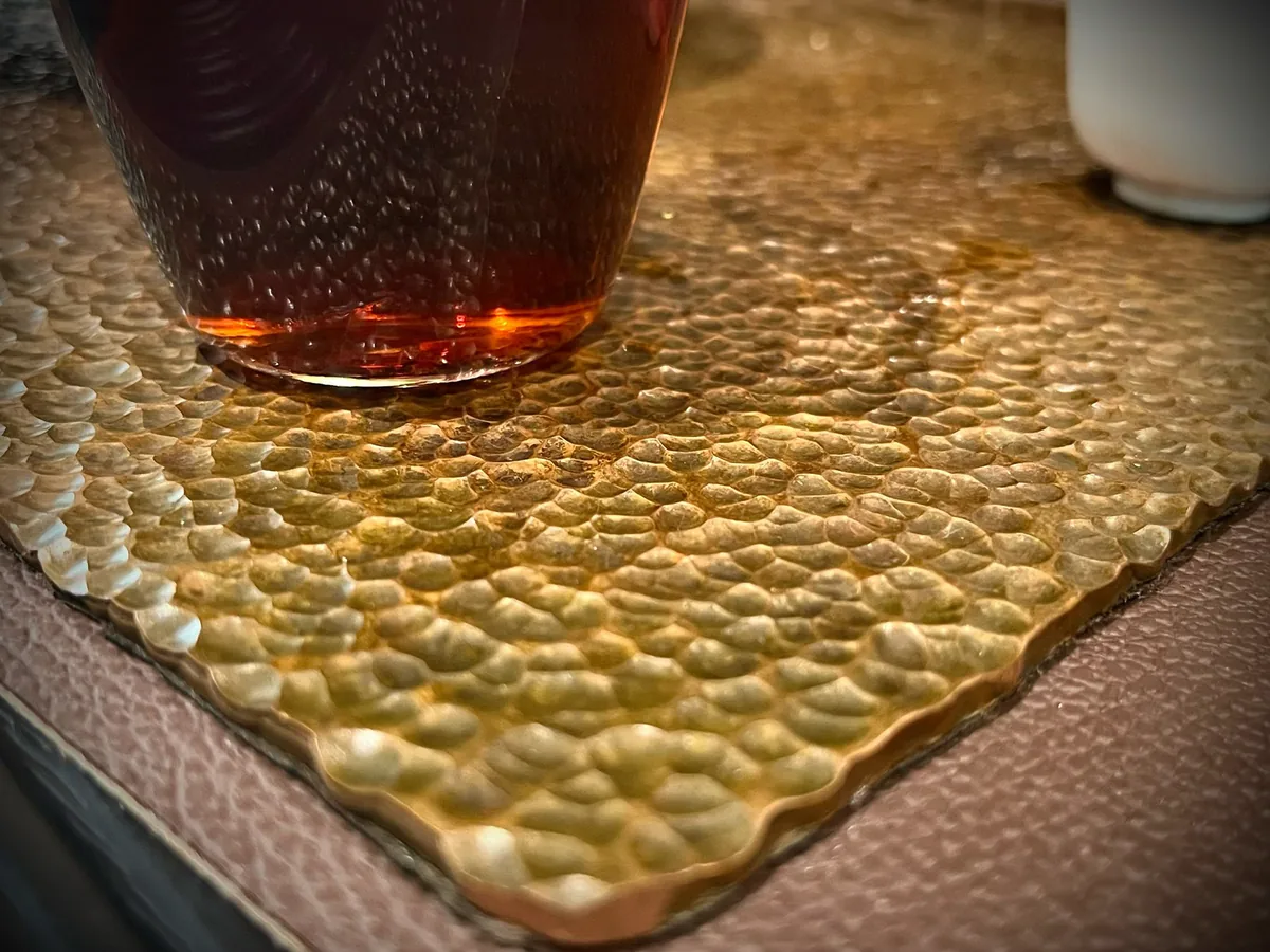 Close-up of hand-hammered gold decorative metal texture